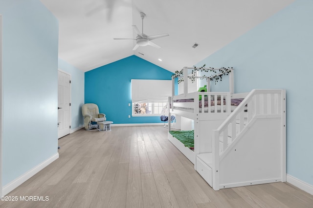 unfurnished bedroom with baseboards, visible vents, lofted ceiling, ceiling fan, and wood finished floors