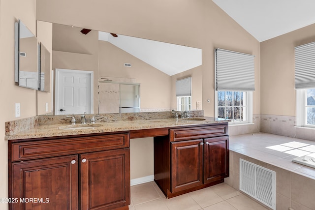 full bathroom with a stall shower, visible vents, vaulted ceiling, and double vanity