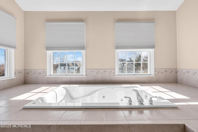 full bathroom featuring a healthy amount of sunlight and a jetted tub