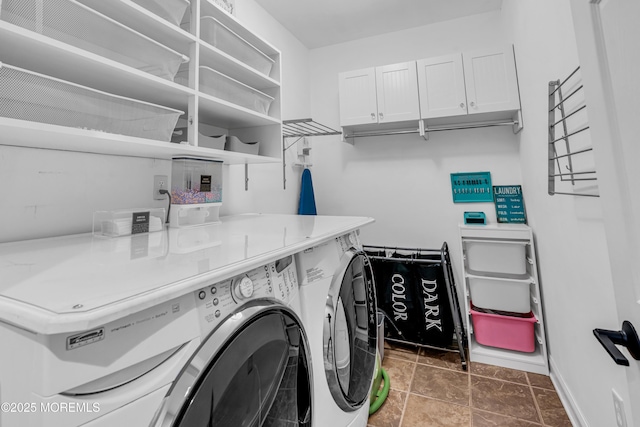 laundry area with washing machine and dryer, cabinet space, and baseboards