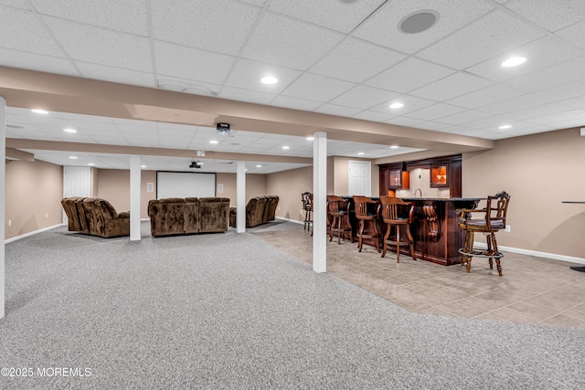 interior space featuring a dry bar, baseboards, light colored carpet, and recessed lighting