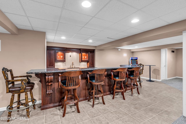 bar with light tile patterned floors, baseboards, indoor wet bar, and recessed lighting