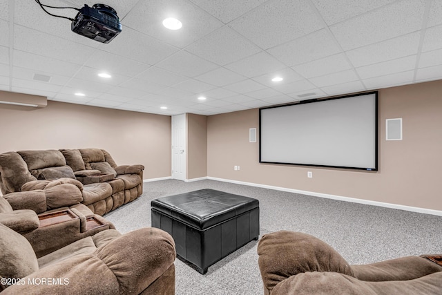 carpeted home theater room with a paneled ceiling, baseboards, and recessed lighting