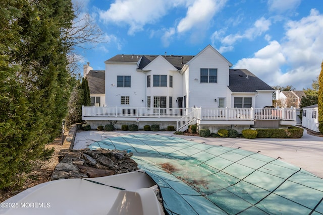 view of swimming pool with a deck, a patio area, and a covered pool