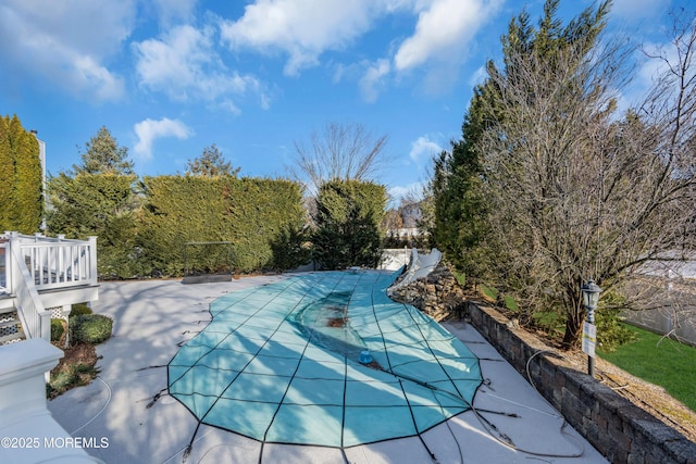 view of swimming pool with a patio area and a covered pool