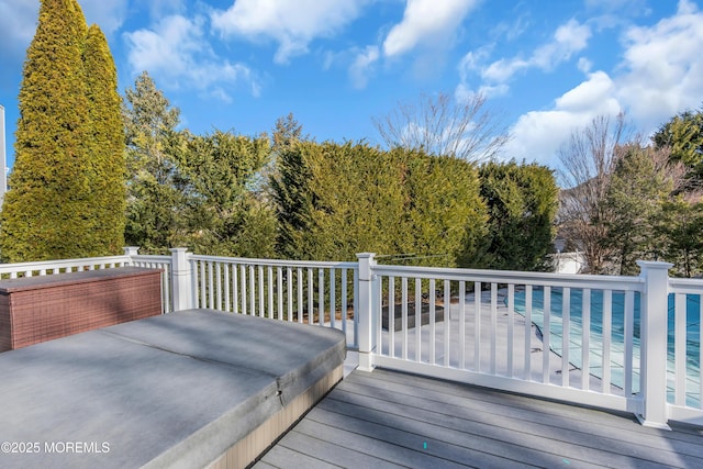 wooden deck featuring a swimming pool