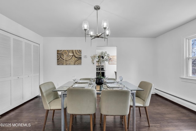 dining area featuring dark wood-type flooring, a notable chandelier, and baseboard heating