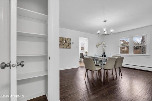 dining area featuring a chandelier, dark wood-style flooring, and baseboards