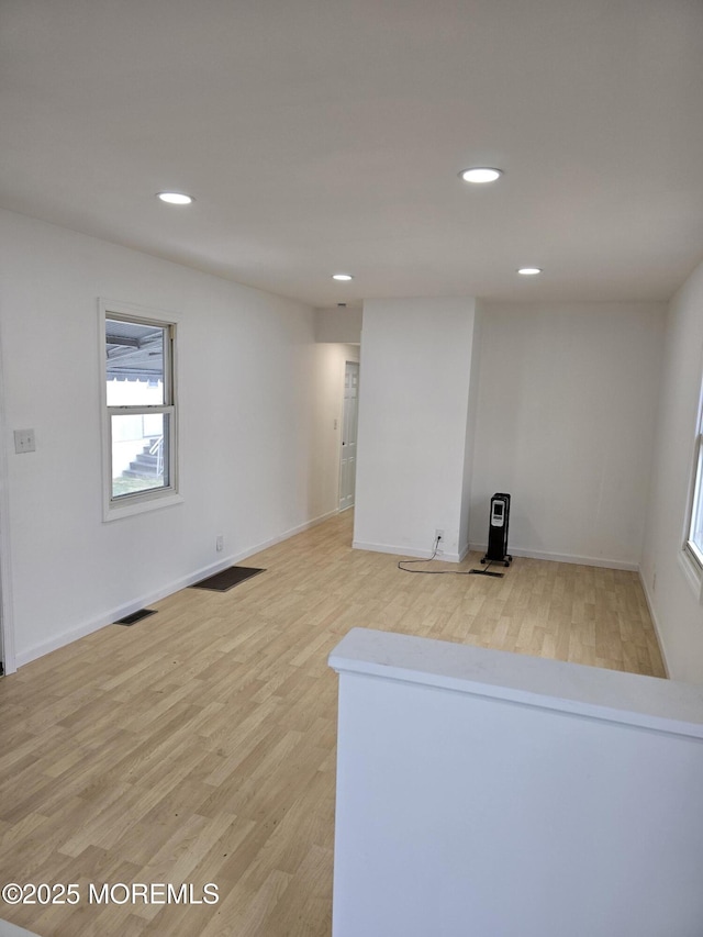 unfurnished room featuring visible vents, baseboards, light wood-style flooring, and recessed lighting