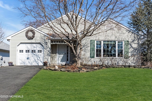 ranch-style house with a garage, driveway, and a front lawn