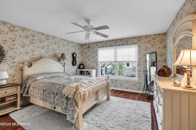 bedroom featuring baseboards, ceiling fan, dark wood-style flooring, and wallpapered walls