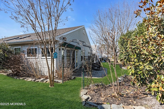 view of side of home with a lawn