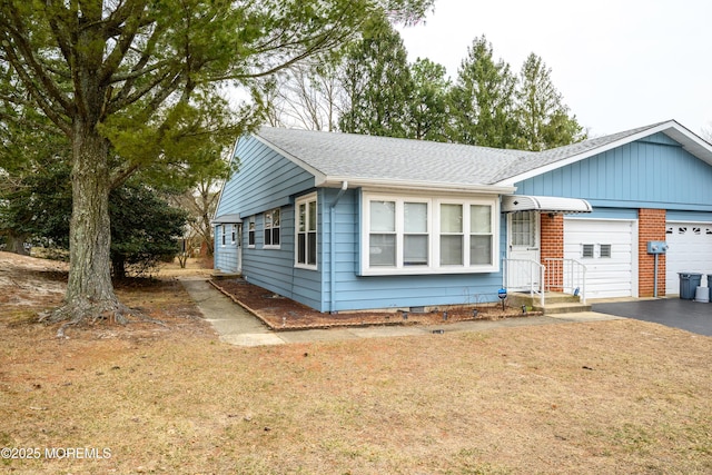 single story home with aphalt driveway, a shingled roof, an attached garage, a front yard, and crawl space