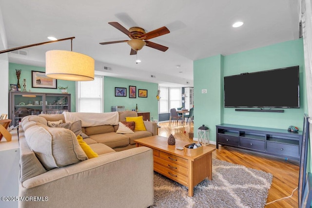 living room featuring ceiling fan, wood finished floors, visible vents, and recessed lighting