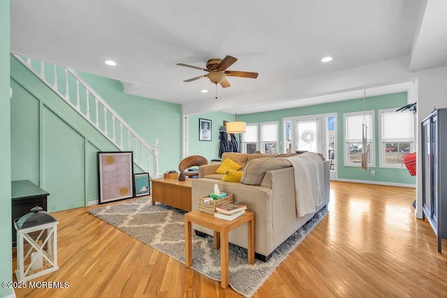 living room featuring light wood finished floors, stairs, a ceiling fan, and recessed lighting