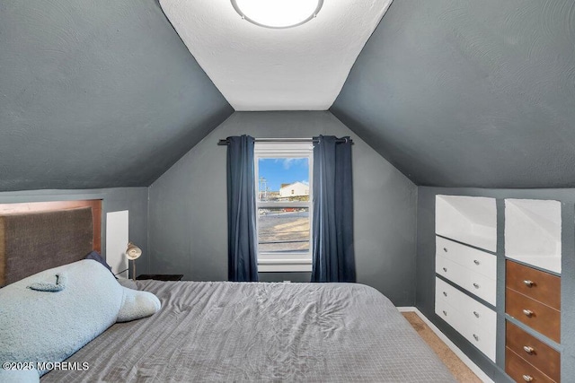 bedroom featuring a textured ceiling, light carpet, lofted ceiling, and baseboards