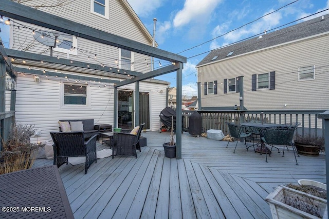 wooden terrace with outdoor lounge area and outdoor dining space