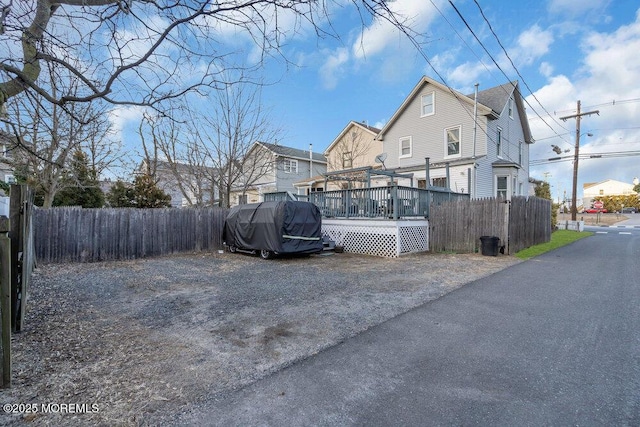 exterior space featuring fence and a wooden deck