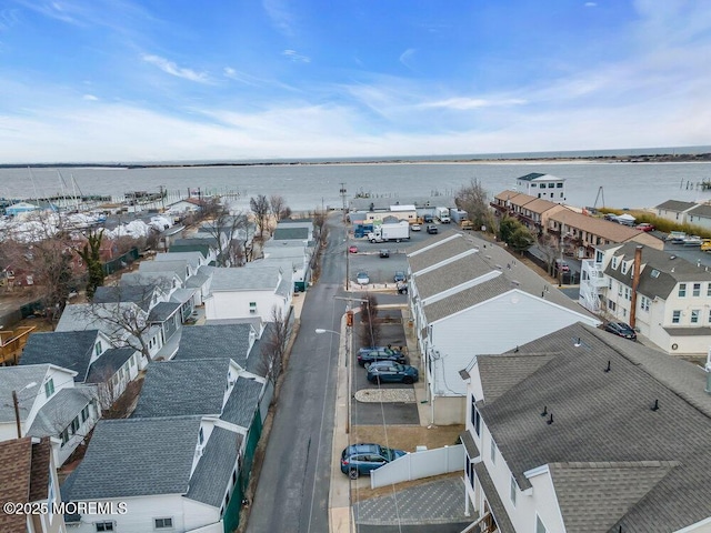 bird's eye view featuring a water view and a residential view