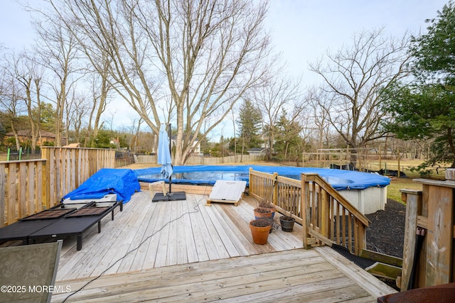 deck with a fenced in pool