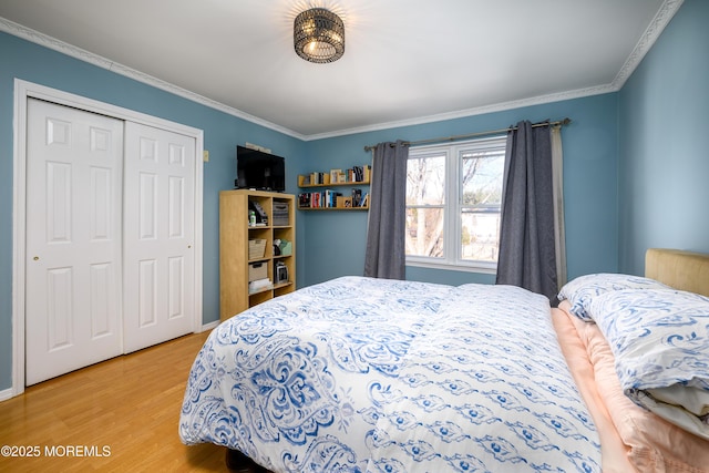 bedroom with ornamental molding, a closet, and light wood-style flooring