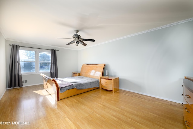 bedroom with light wood-style floors, baseboards, ornamental molding, and a ceiling fan