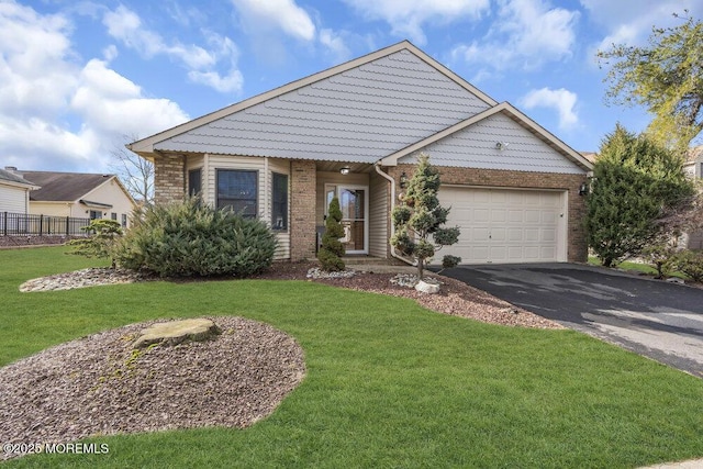 view of front of home featuring an attached garage, a front yard, aphalt driveway, and brick siding