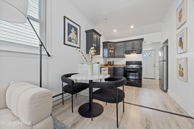 dining room with crown molding, light wood finished floors, recessed lighting, a baseboard heating unit, and baseboards