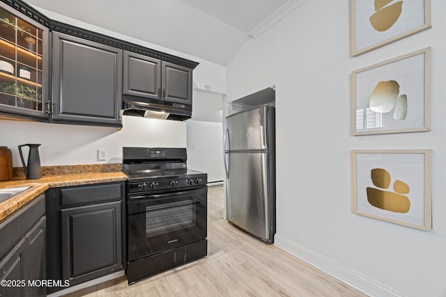 kitchen with light wood finished floors, black range with gas cooktop, freestanding refrigerator, light countertops, and under cabinet range hood