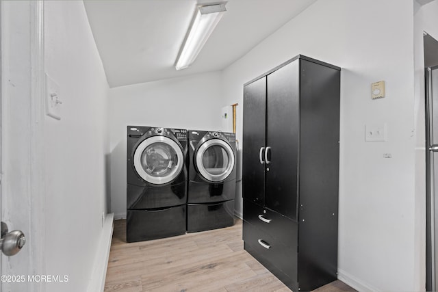 washroom with laundry area, independent washer and dryer, and light wood-style floors