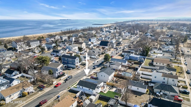 drone / aerial view featuring a residential view and a water view