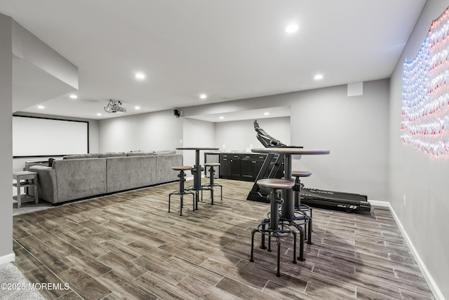 exercise area with a bar, wood tiled floor, baseboards, and recessed lighting