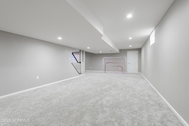 basement featuring carpet floors, stairs, baseboards, and recessed lighting