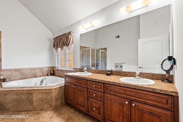 full bath featuring double vanity, visible vents, vaulted ceiling, and a sink