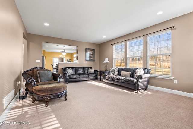 living room with an inviting chandelier, recessed lighting, baseboards, and light colored carpet