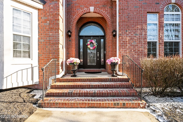 view of exterior entry with brick siding