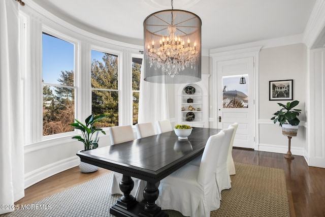 dining area featuring dark wood-style floors, baseboards, and a notable chandelier