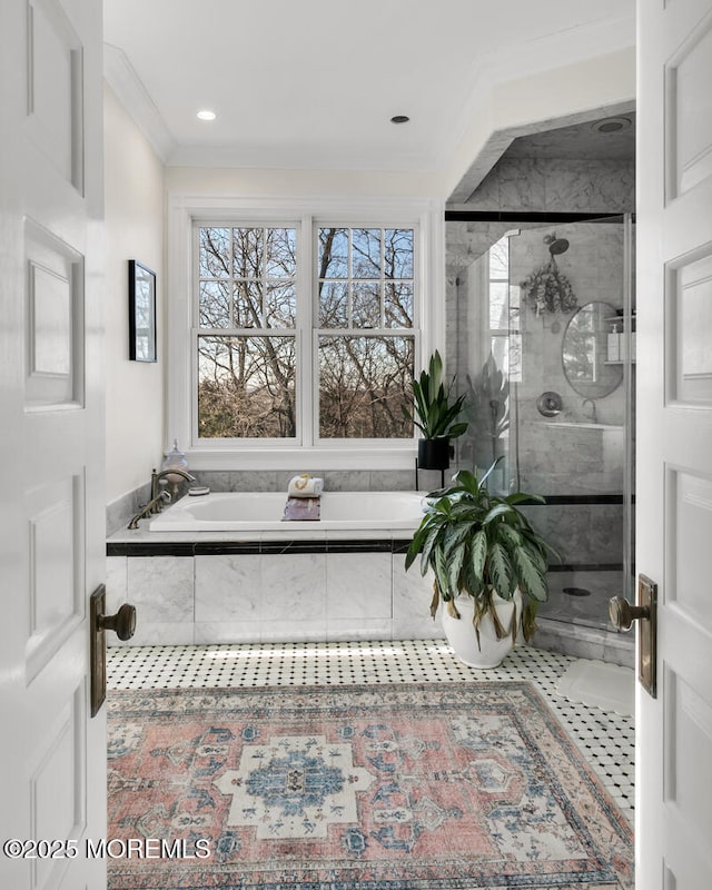 bathroom with ornamental molding, a stall shower, and a garden tub