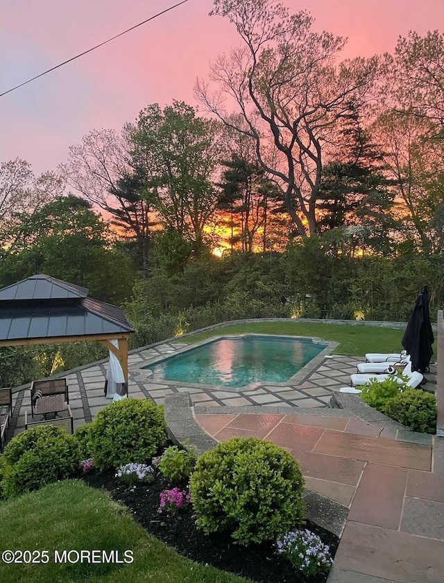 outdoor pool with a patio area and a gazebo