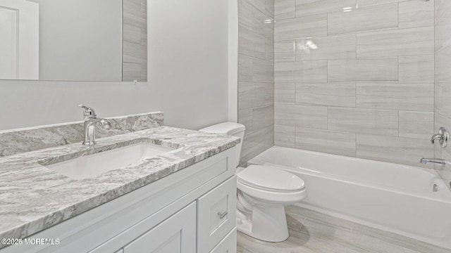 full bathroom featuring bathtub / shower combination, vanity, and toilet