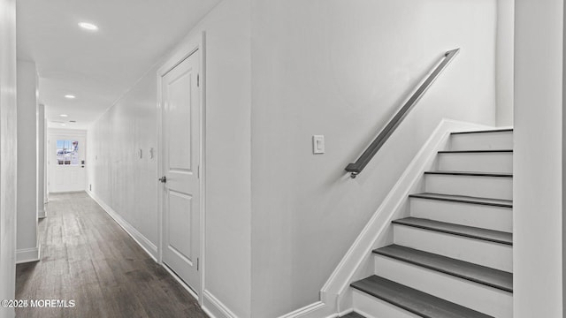 stairs with baseboards, wood finished floors, and recessed lighting