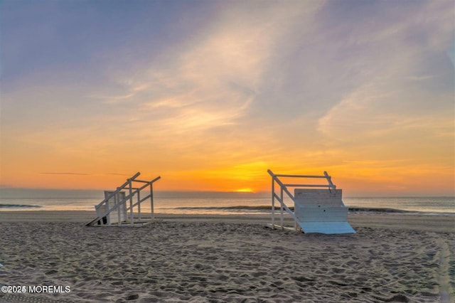 exterior space featuring a water view and a view of the beach