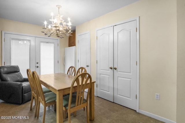 dining room with french doors, an inviting chandelier, tile patterned flooring, and baseboards