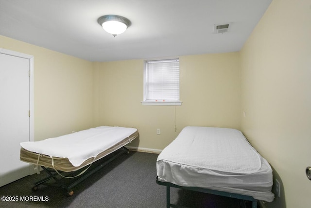 carpeted bedroom featuring visible vents and baseboards