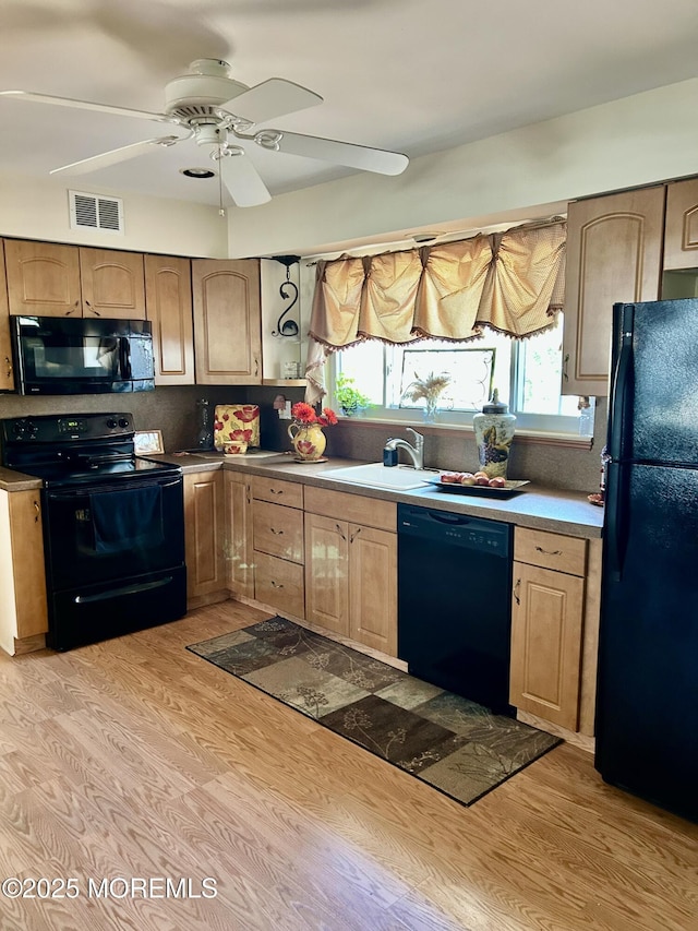 2 Apache Dr, Toms River, NJ 08753 - kitchen with a sink, light wood-type flooring, visible vents, black appliances, and ceiling fan
