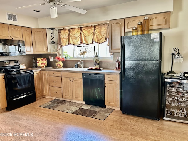2 Apache Dr, Toms River, NJ 08753 - kitchen with light brown cabinetry, a sink, light wood-style floors, visible vents, and black appliances
