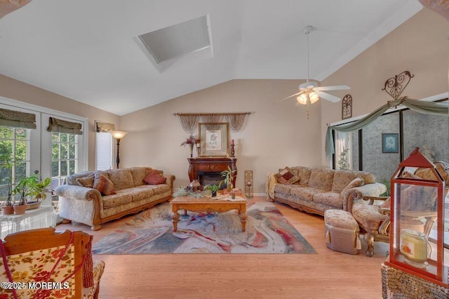 2 Apache Dr, Toms River, NJ 08753 - living room featuring french doors, ceiling fan, wood finished floors, a glass covered fireplace, and vaulted ceiling