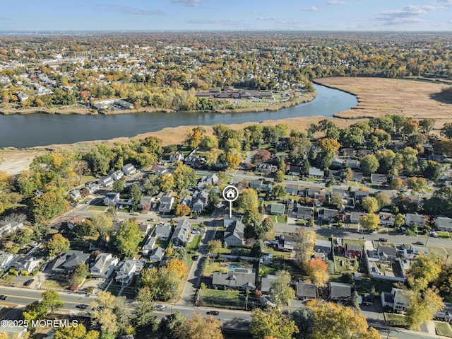 birds eye view of property with a water view and a residential view