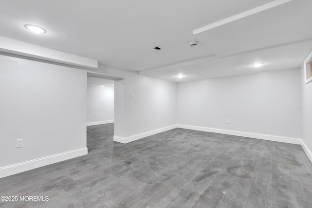 finished basement with baseboards and wood finished floors