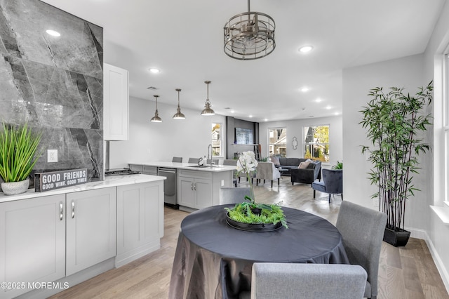 dining room featuring light wood-type flooring and recessed lighting